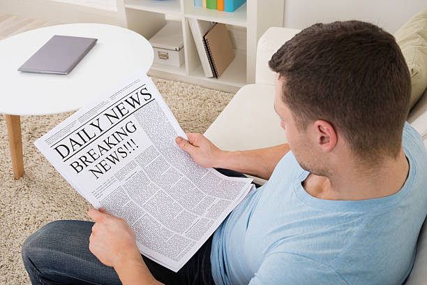 istock Man Reading Breaking News On Newspaper At Home 598541998