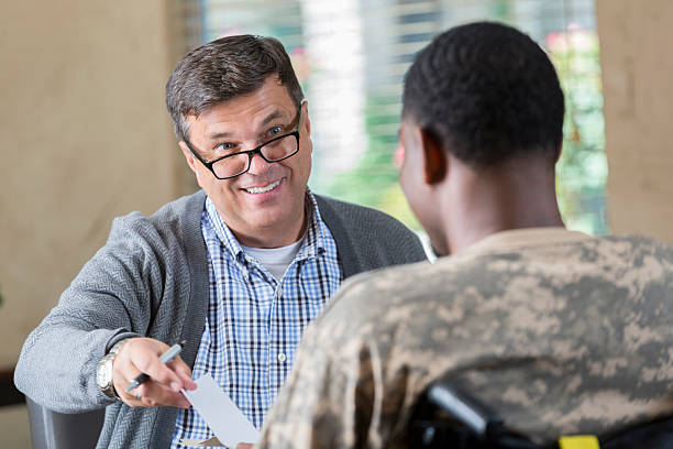 istock Doctor prescribing medication to young soldier during therapy session 598542664
