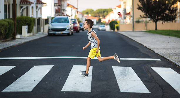 istock Little boy runs across the road 598542688
