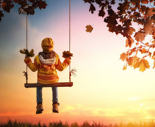 istock kid playing in the autumn 598543148
