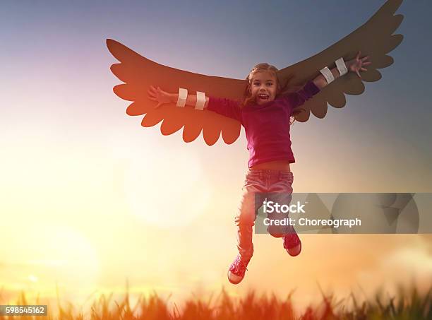 Kid With The Wings Of A Bird Stock Photo - Download Image Now - Aircraft Wing, Child, Girls