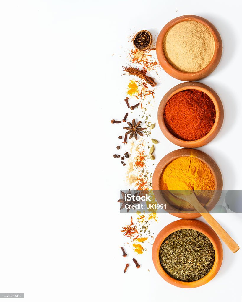 Group of indian spices and herbs on white background. Spices and herb for cooking background and design,Top view spics and herbs on white background,spices content,spices background,Group of indian spices on white background with copy space. Spice Stock Photo