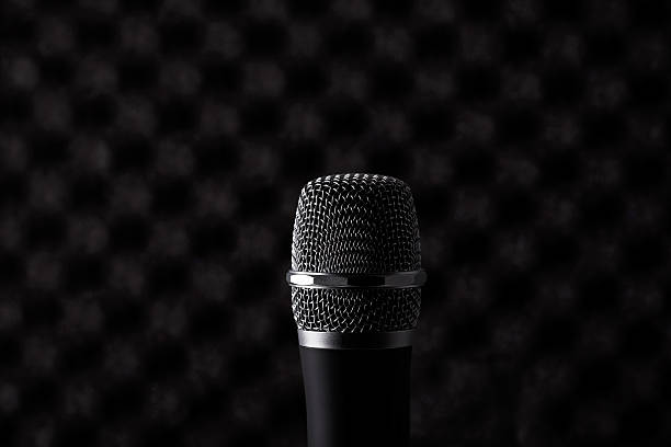 istock Wireless microphone closeup on foam acoustic background 598547934
