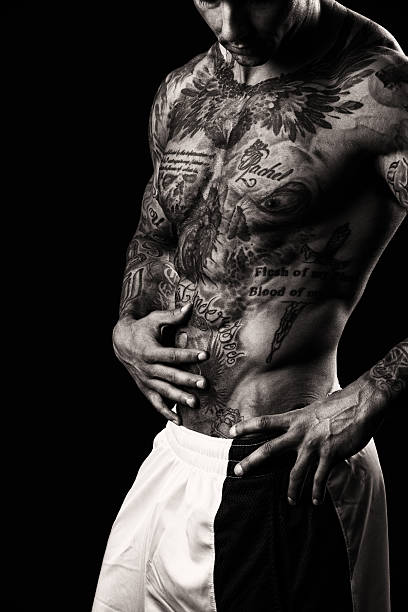 Tattooed Torso of a Muscular Male A young 28 year old, athletic, body builder with numerous tattoos across his skin. chest tattoo men stock pictures, royalty-free photos & images