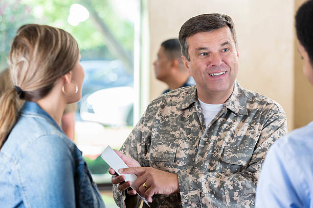istock Recruiter for armed forces meeting young people at recruitment event 598550682