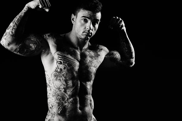 istock Tattooed Muscular Man Flexing His Biceps 598550856