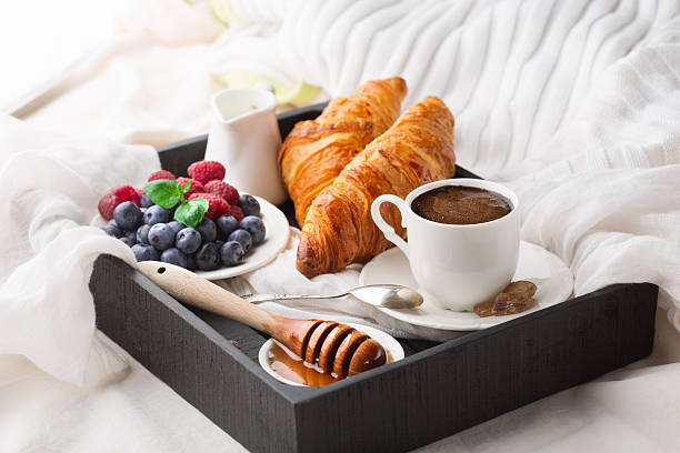 istock Breakfast in bed with cup coffee and croissants 598551022