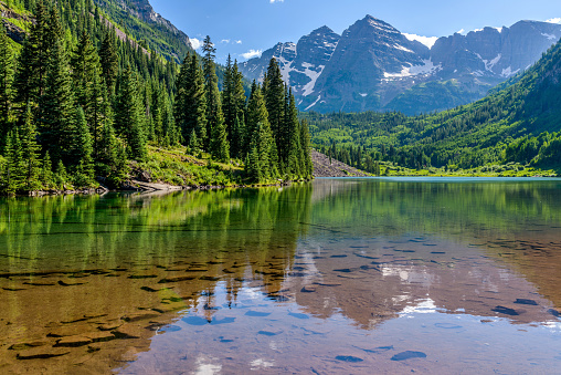 View over the lake Carezza (Italian: Lago di Carezza; German: Karersee) with the Latemar mountain range in the background. It is located in the Dolomites, European Alps, Italy.