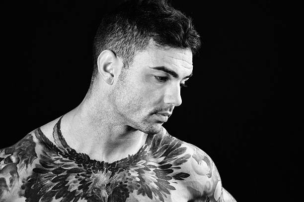 One Latino male looking down and to his left as if in deep thought or feeling depression