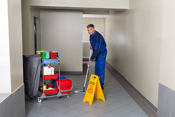 istock Male Worker With Broom Cleaning Corridor 598553656