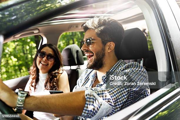 Portrait Of Young Couple Sitting In Car Stock Photo - Download Image Now - Car, Driving, Couple - Relationship