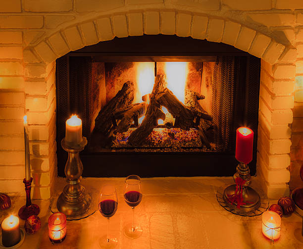 istock Two wine glasses sit among candles on fireplace hearth(P) 598554452