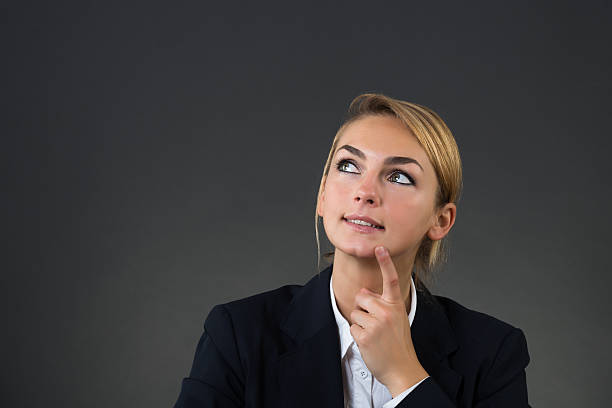istock Thoughtful Young Businesswoman Looking Up 598555646