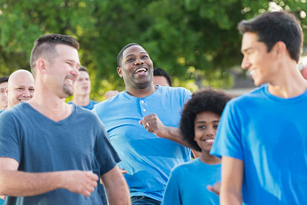 istock Multi-ethnic gorup of boys and men wearing blue shirts 598555650