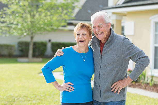 istock Senior couple standing together outside house 598555828