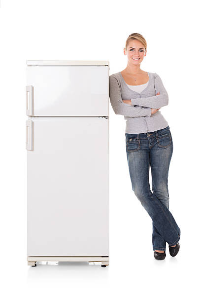 istock Woman Leaning On Refrigerator Over White Background 598555902