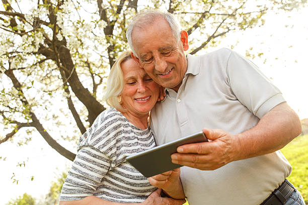 istock Smiling senior couple in park 598556444