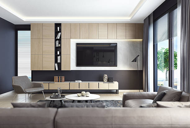 This is modern contemporyry dark black luxury style living room interior with leather sofa and TV. Here are various shades and finishes that mix together beautifully. And silver is the hottest metallic tone in interior design. A plethora of colors and textures were layered to create a feeling of warmth and luxury style. Fabrics include sumptuous velvet for the sofa and armchair, silk cushions and curtain with Italian cashmere carpet. Modern luxury black style apartment with leather sofa.