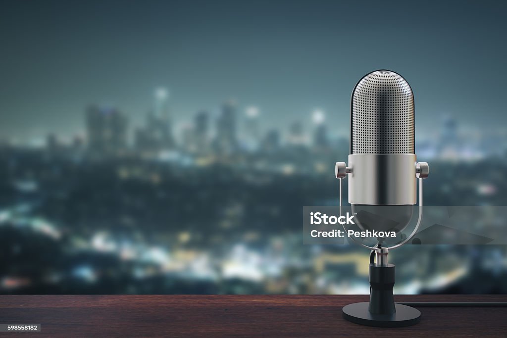 Mic on night city background Wooden surface with microphone on blurry night city background with copy space. 3D Rendering Radio Stock Photo