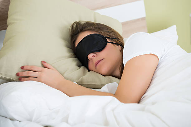 istock Woman Sleeping On Bed With An Eye Mask 598558400