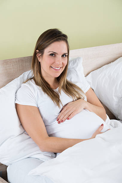 istock Pregnant Woman Sitting In Bed 598558508