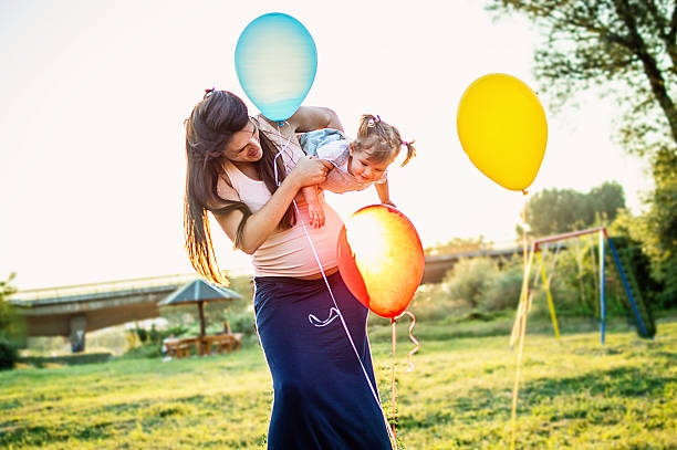istock Pregnant mom and happily daughter 598558596