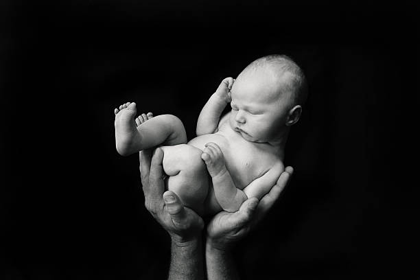 istock Newborn Baby in Father's Hands 598559330