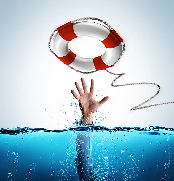 concepto de rescate - salvavidas como ayuda del empresario que se ahoga - rescate fotografías e imágenes de stock