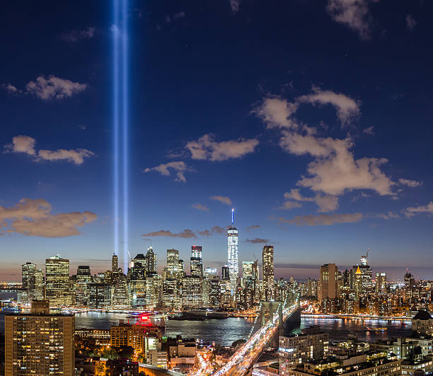 Brooklyn Bridge and Manhattan skyline with The Tribute in Light stock photo