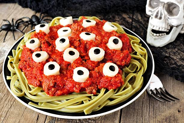 istock Halloween eyeball pasta scene with decor on aged wood 598559868