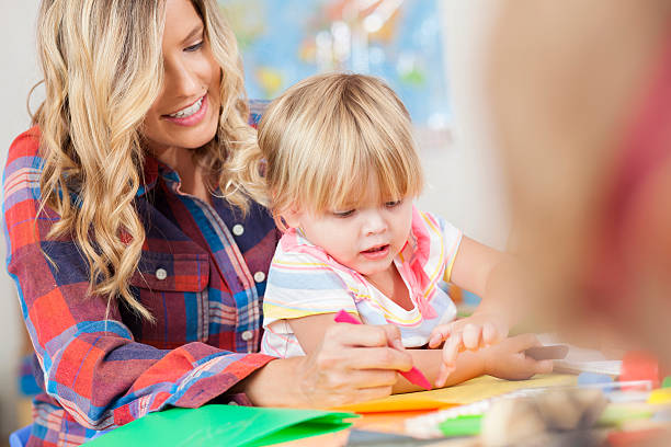 istock Mother and daughter draw together during preschool class 598560026