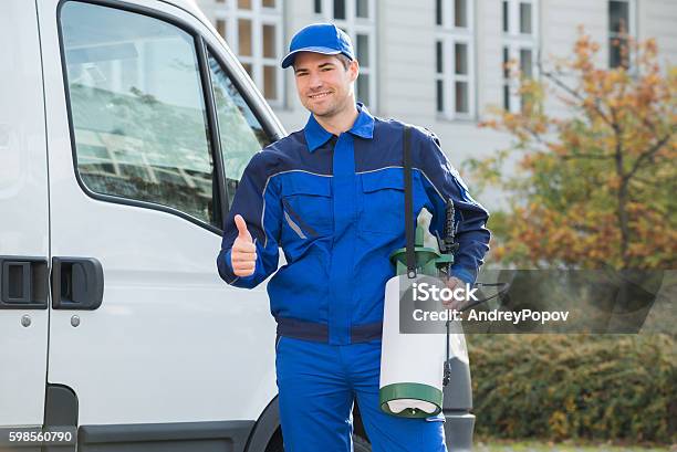 Pest Control Worker Showing Thumbsup By Truck Stock Photo - Download Image Now - Pest Control Equipment, Exterminator, Young Men