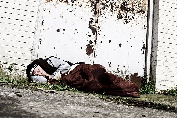 istock homeless man sleeping in doorway 598563474
