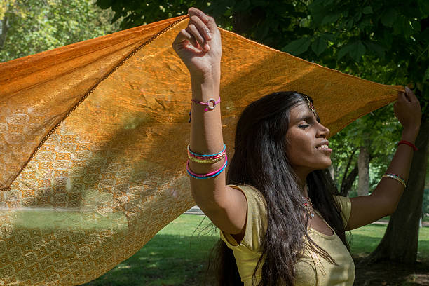 istock Happy indian beautiful young woman dancing 598564032