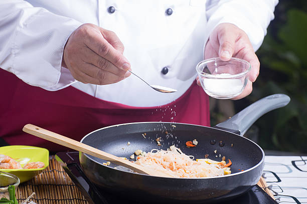 istock Chef putting sugar for cooking Pad Thai 598564438