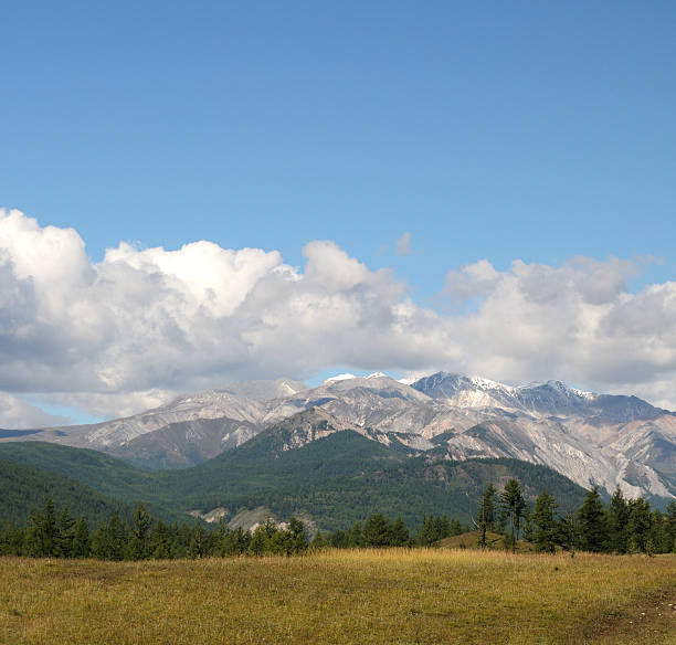 istock Blue sky and cumulus clouds over the Eastern Sayan Mountains 598565918