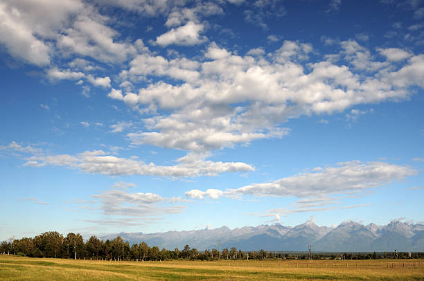 istock Blue sky and cumulus clouds over the Eastern Sayan Mountains 598566044