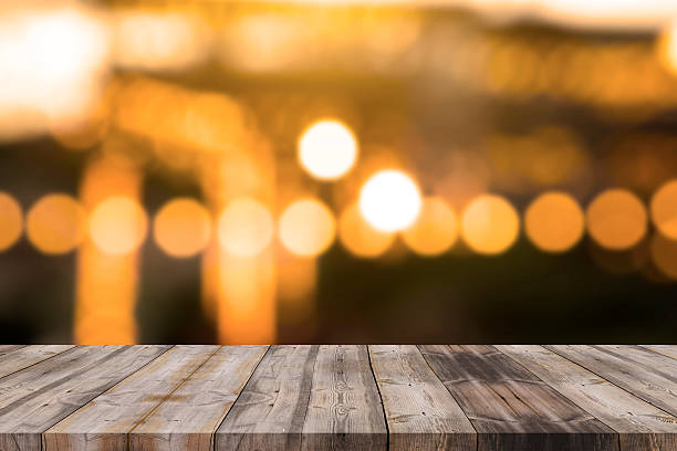 istock Wood table top on golden bokeh abstract background 598566544