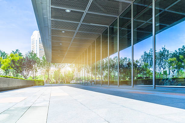 istock trees and blue sky reflected on clean glass wall 598567778