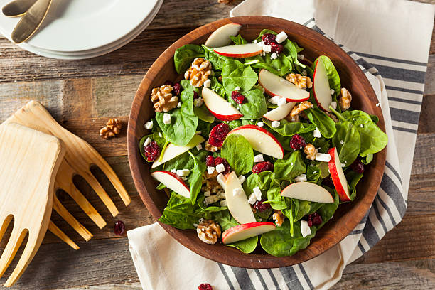 Homemade Autumn Apple Walnut Spinach Salad Homemade Autumn Apple Walnut Spinach Salad with Cheese and Cranberries food state stock pictures, royalty-free photos & images