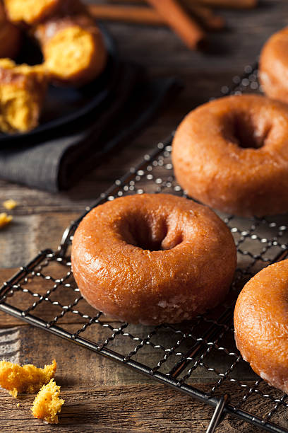 istock Homemade Glazed Autumn Pumpkin Donuts 598567996