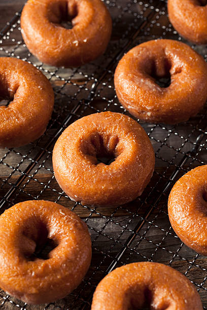 istock Homemade Glazed Autumn Pumpkin Donuts 598568010