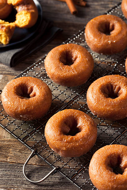 istock Homemade Glazed Autumn Pumpkin Donuts 598568106