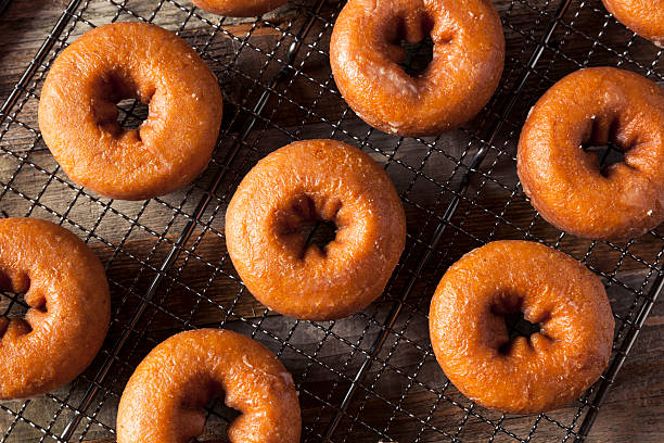 istock Homemade Glazed Autumn Pumpkin Donuts 598568138