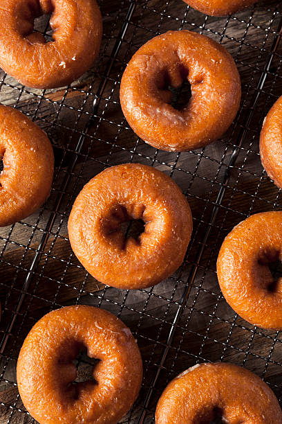 istock Homemade Glazed Autumn Pumpkin Donuts 598568148