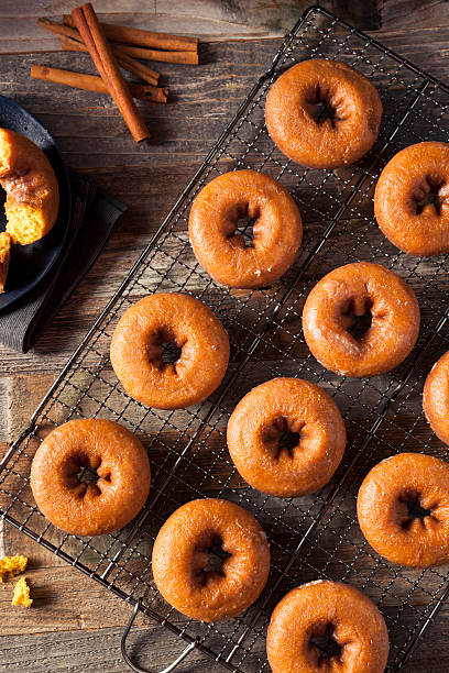 istock Homemade Glazed Autumn Pumpkin Donuts 598568170