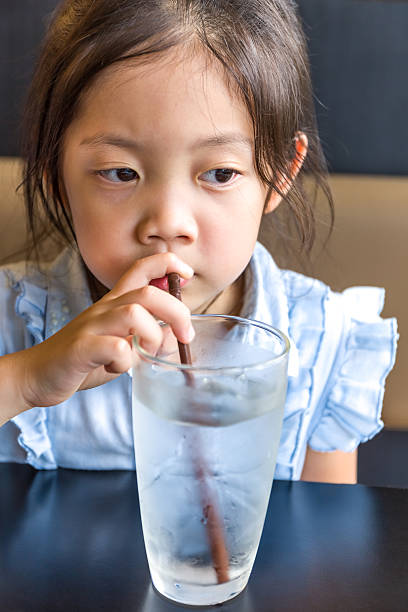 istock Asian Child Drinking Water from Glass 598572656