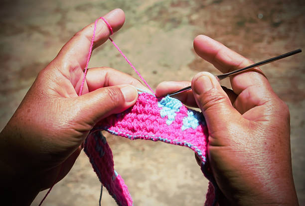 istock Close-up of hands knitting 598573520