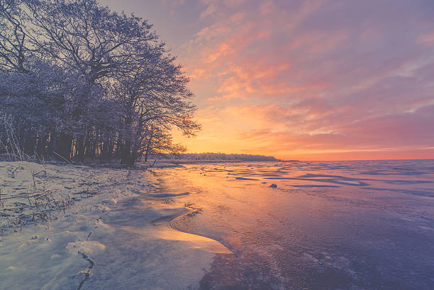 istock Violet sunrise over a frozen lake 598666852