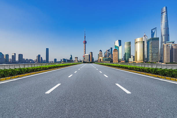 istock clean asphalt road with city skyline background 598667256